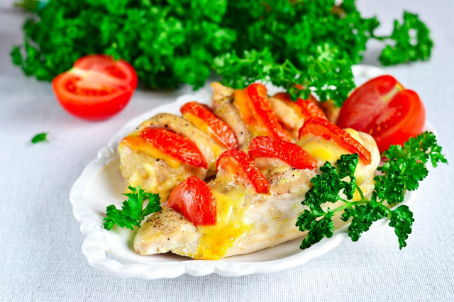 Chicken fillet with tomato and cheese in the oven