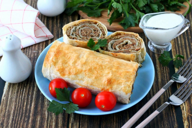 Pita bread roll with minced meat in the oven