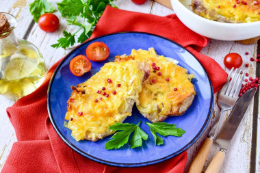 Pork with onions and cheese baked in the oven