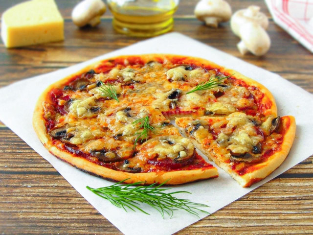 Pizza with champignons sausage and cheese in the oven
