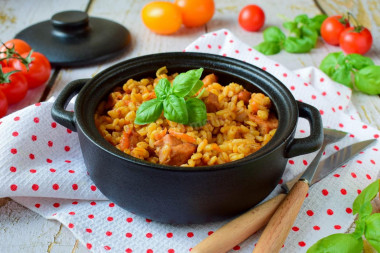 Pearl barley in a pot in the oven with meat