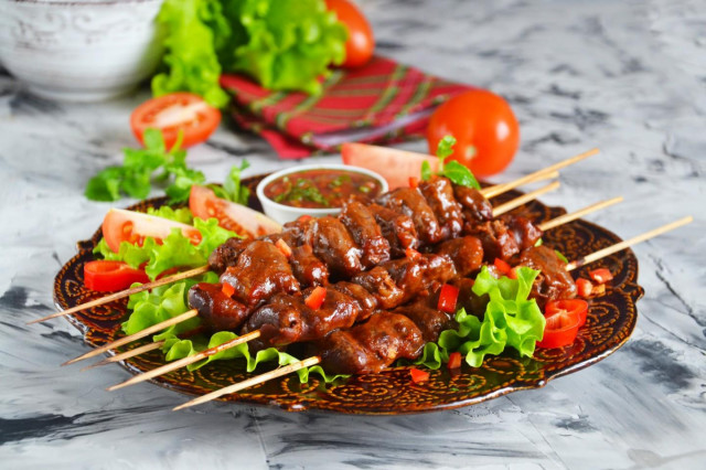 Barbecue of chicken hearts in the oven on skewers