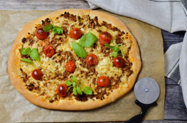 Pizza with minced meat in the oven