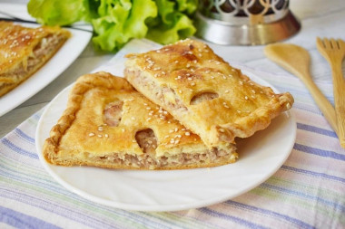 Puff pastry pie with minced meat in the oven