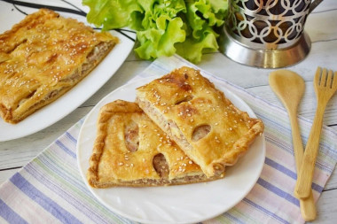 Puff pastry pie with minced meat in the oven