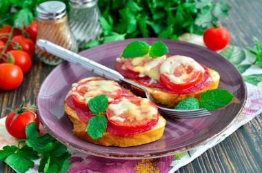 Hot sandwiches with sausage cheese and tomatoes in the oven