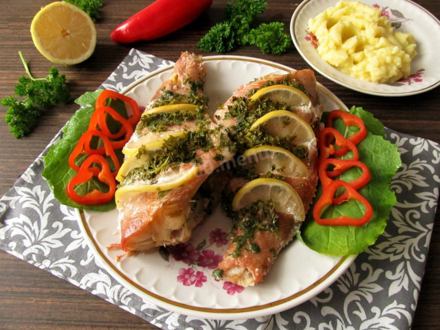 Sea bass baked in foil in the oven with lemon