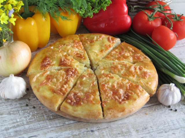 Yeast khachapuri in the oven with cheese