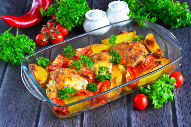 Potatoes with chicken and tomatoes in the oven