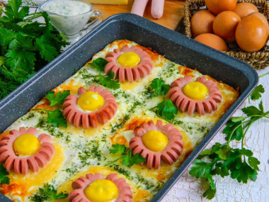 Sun casserole from mashed potatoes with sausages in the oven