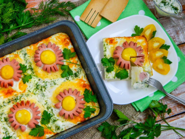 Sun casserole from mashed potatoes with sausages in the oven