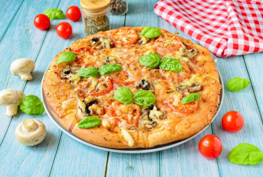 Pizza with mushrooms, tomatoes and cheese