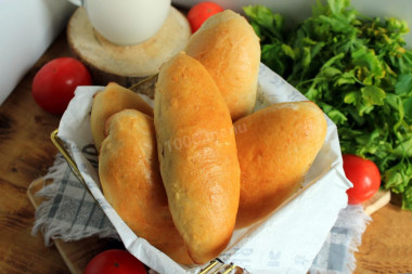 Baked pies in the oven with cabbage