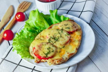 Chicken breast chop in the oven with cheese and tomatoes