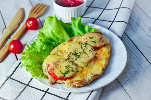 Chicken breast chop in the oven with cheese and tomatoes