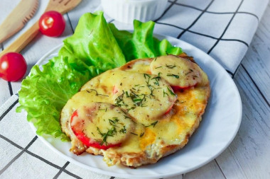 Chicken breast chop in the oven with cheese and tomatoes