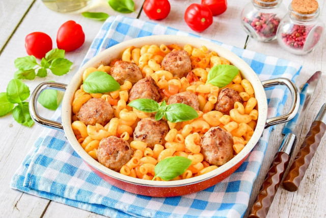 Pasta with meatballs in a frying pan
