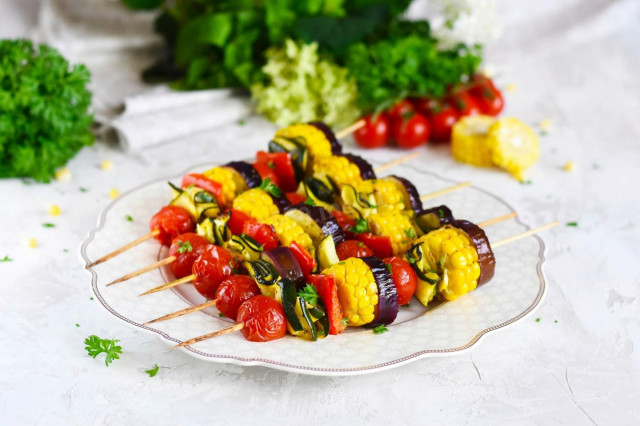 Shish kebab with vegetables in the oven on skewers