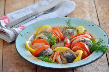 Mackerel with tomatoes baked in the oven with onions