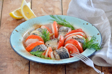 Mackerel with tomatoes baked in the oven with onions