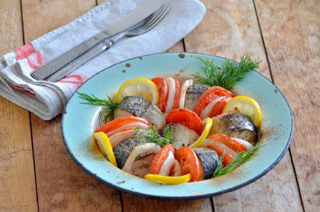 Mackerel with tomatoes baked in the oven with onions