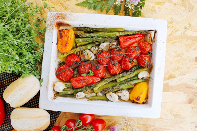 Fresh green asparagus in the oven with vegetables