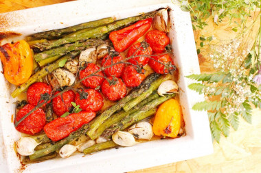 Fresh green asparagus in the oven with vegetables