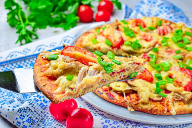 Pizza with chicken and mushrooms in oven