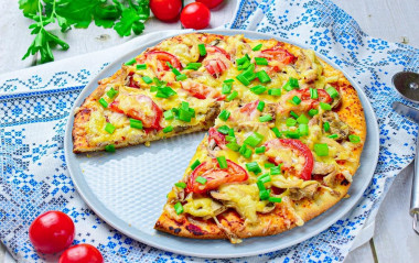 Pizza with chicken and mushrooms in oven