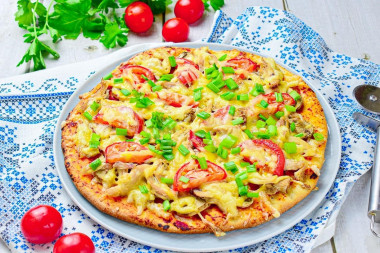 Pizza with chicken and mushrooms in oven