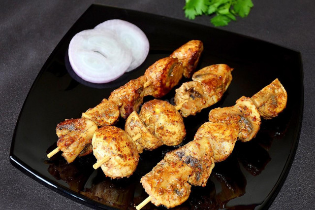 Champignons on skewers in the oven