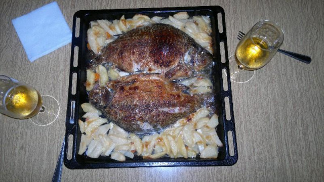 Crucian carp baked with potatoes in the oven with mayonnaise