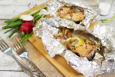 Salmon steak in foil in the oven