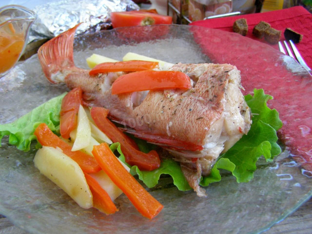 Sea bass baked with potatoes in the oven in foil