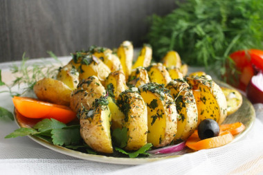 Potatoes spiral on skewers in the oven