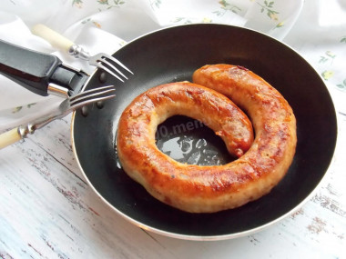 Homemade sausage fried in a pan