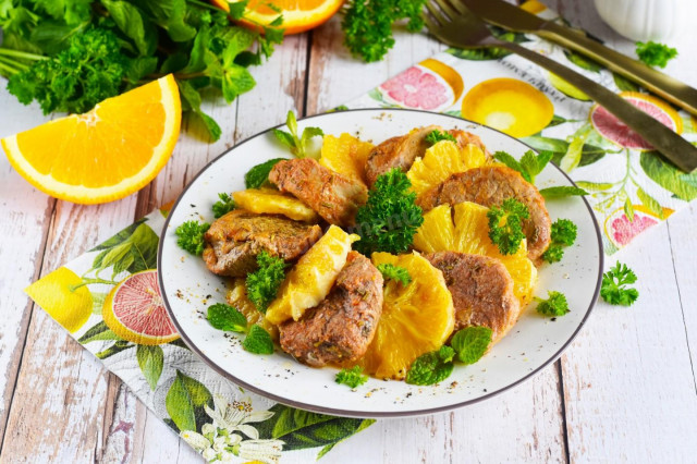 Pork meat with oranges in the oven