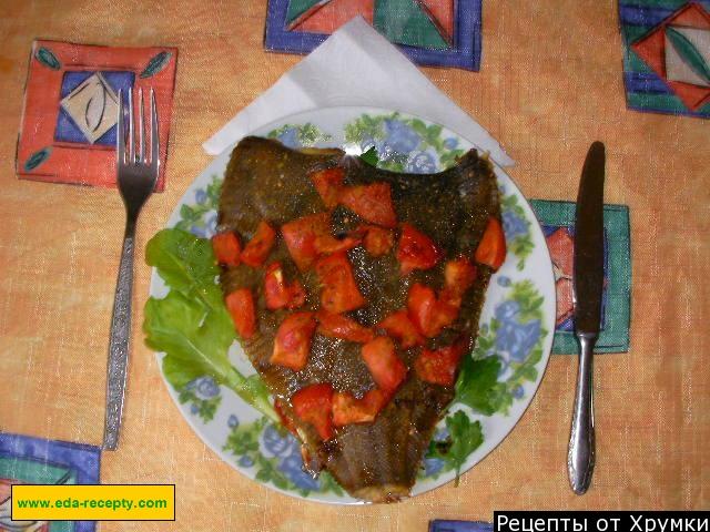 Flounder fish baked with tomatoes in the oven