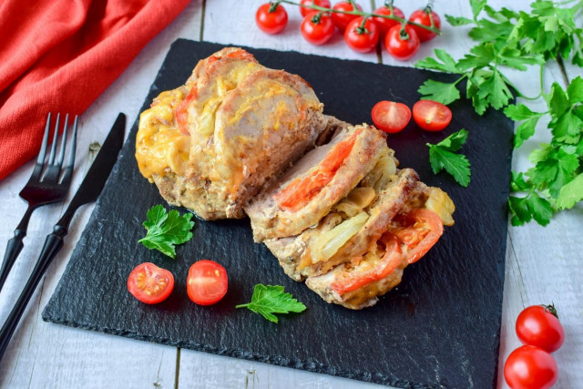 Pork with cheese and tomato in foil in the oven