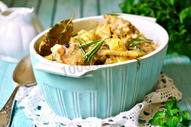 Rabbit in a pot with potatoes in the oven with sour cream