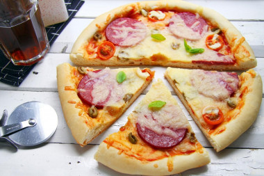 Pizza on thick dough in the oven