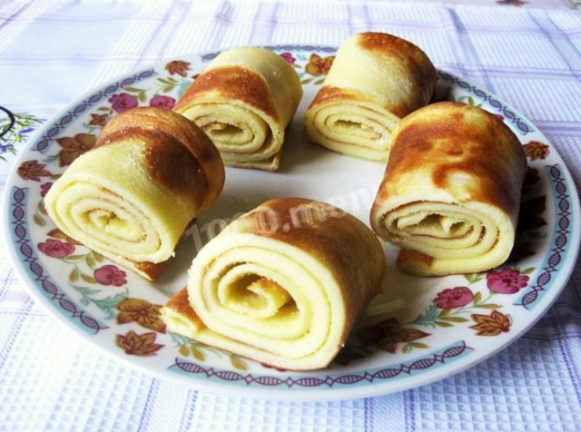 Pancakes with low-fat milk on a baking sheet in the oven