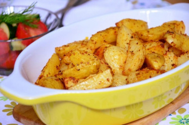 New potatoes baked with herbs and garlic in the oven