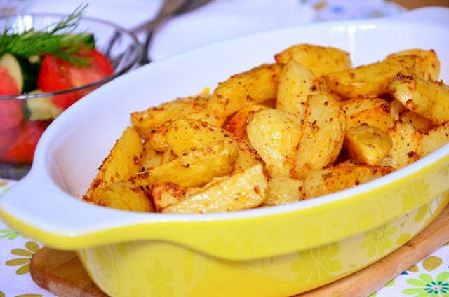 New potatoes baked with herbs and garlic in the oven