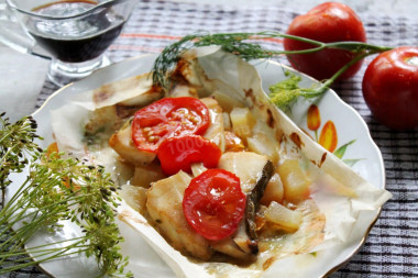 Cod fillet with zucchini onion tomatoes in the oven