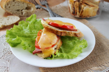 Sandwiches in the oven with boiled sausage and cheese