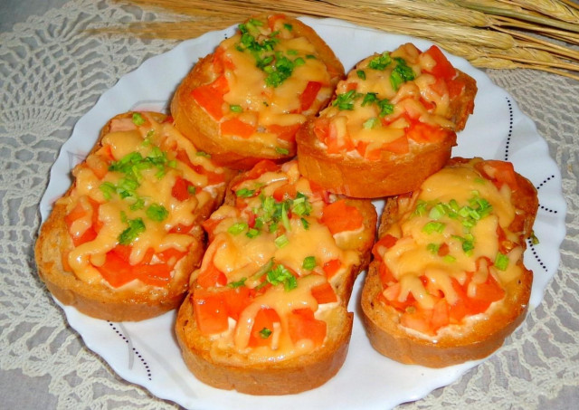 Sandwiches in the oven with hard cheese, mayonnaise and tomatoes