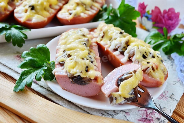 Sausages in the oven with cheese and mushrooms
