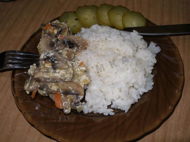 Pollock with mushrooms in sour cream in the oven