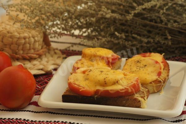 Hot sandwiches with tomatoes and cheese in the oven